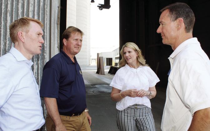 Above: Austin Lafferty, Cindy Lankford, James Lankford, U.S. Senator, and Todd Lafferty Thursday during a tour of Wheeler Brothers. Below, Austin Lafferty explains the difficulties facing farmers to the senator.