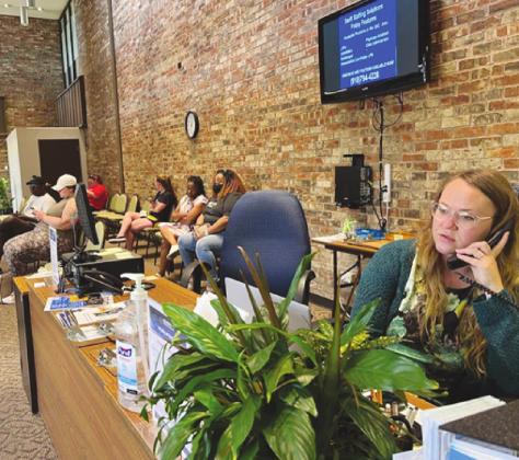 Sabria Blackwell, a Career Coordinator at the Oklahoma Works American Job Center in Oklahoma City, took a call on July 6. Oklahomans can file unemployment claims or appeals, find job postings and receive training and other guidance at the center. (Lionel Ramos/Oklahoma Watch)