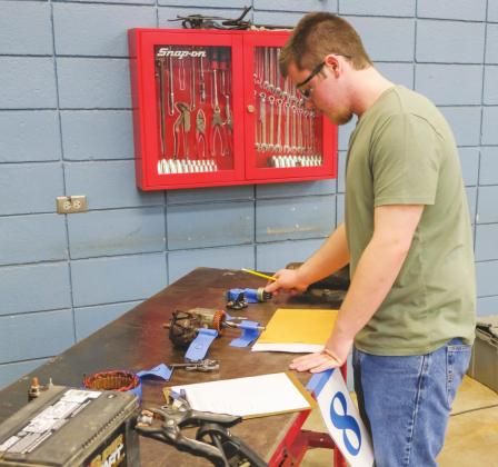 Gannon Grubs, Watonga home-school student, chooses from a selection of automotive parts at the Division SkillsUSA contest in Fairview. He placed fourth in his category. CTTC | Watonga Republican