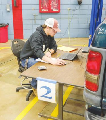 Brandon Wiggins, Watonga High School student, works at a laptop diagnosing an engine problem at the Division SkillsUSA contest at Fairview. He was one of four CTTC students who won a local contest to advance to the division competition. CTTC | Watonga Rep