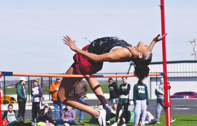 Kiyla Cooper participates in the high jump during a track meet.