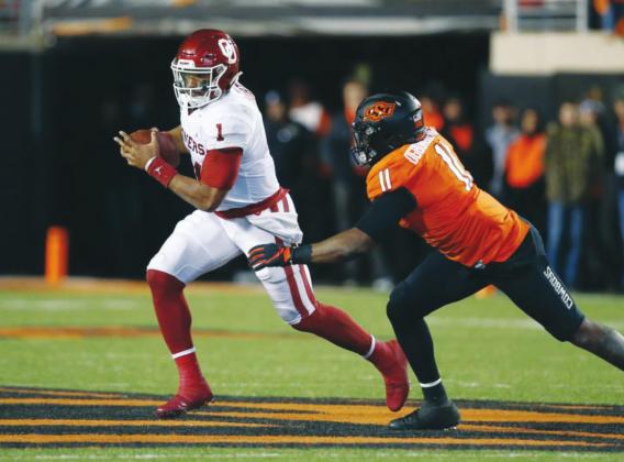 (Above) Former University of Oklahoma quarterback Jalen Hurts (1) is pursued by Oklahoma State University linebacker Amen Ogbongbemiga (11) on Nov. 30, 2019, in the second half of the 2019 Bedlam Series college football game at Boone Pickens Stadium in Stillwater. Sue Ogrocki AP Photo