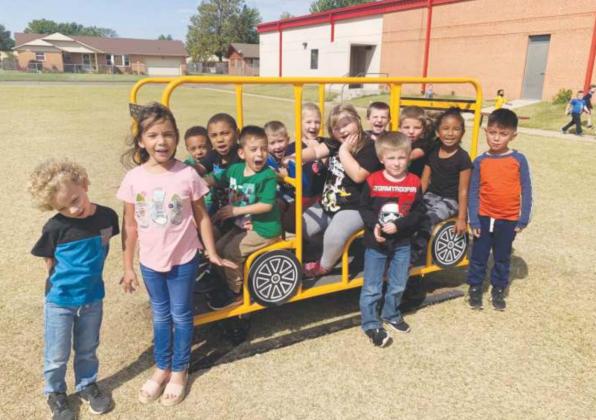 Watonga Elementary students enjoying their new school bus toy. The new toy was purchsed by the Watonga School Board for the little playground over the summer, and has just recently been delivered and installed. Watonga Public Schools Watonga Republican