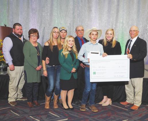 Tyler Sawyer receiving his scholarship alongside was Becky Bedwell, Blaine County OSU 4-H Educator; Karl Riffle, Okeene Vocation Agriculture Instructor; Parents of Tyler, Trisa and Brandon Sawyer; Elizabeth Chamber, State 4-H president; David Gammill, Vice-Chairman of the of the Oklahoma Wheat Commission, JanLee Rowlett, Oklahoma Department of Agriculture; Keith Kisling, Oklahoma Wheat Research Foundation.