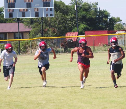 Players from the Geary High School varsity football team run sprints on Aug. 15, 2019, at the end of practice. Andrew Salmi I The Geary Star