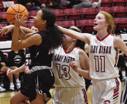 Geary’s Kandace Pitts reaches in for the ball during a game last week. The Lady Bison fell to Watonga 58- 21. (Photo provided by Brenda Geels)