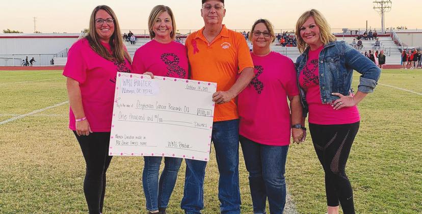 Watonga Public Schools honored Breast Cancer Awareness Month Thursday with a "Pink Out" fundraiser to benefit cancer research at OU Medical Center. The district also honored local man Steve Coney, who is currently battling cancer, before Watonga's game against Crescent. From left: Kelly Manke, Michelle Hilterbran, Steve Coney, Kim Coney and Mindy Wigington. (Photo provided by Kyle Hilterbran)