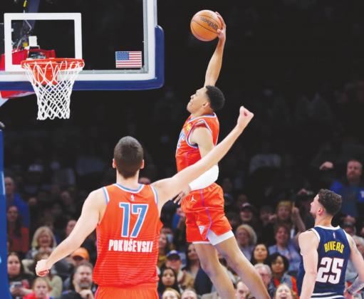 Oklahoma City Thunder forward Darius Bazley goes up for a dunk ahead of Denver Nuggets guard Austin Rivers as Thunder center Aleksej Pokusevski looks on during the second quarter at Paycom Center. (Alonzo Adams-USA TODAY Sports)