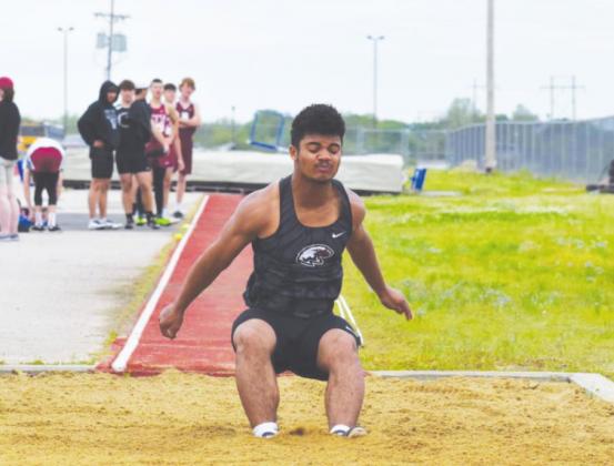 Below: Joe Jackson competes in the long jump at the Okemah track and field meet Saturday. Jackson’s top jump was 18’2.75”. (Photos provided by Brenda Geels)
