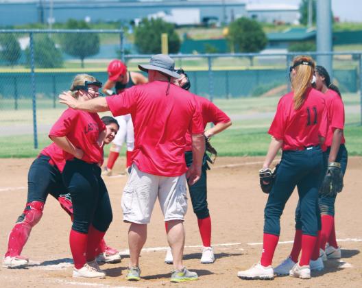 (Above) Geary High School varsity fast-pitch first-year head coach Rick Scott talks with his Lady Bison infielders on Tuesday, June 16 during a Hinton Summer League softball scrimmage against Navajo High School. Andrew Salmi The Geary Star