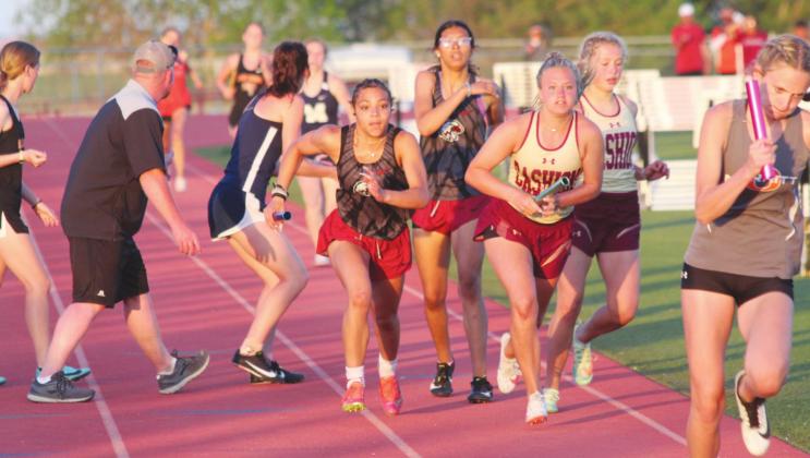 Watonga's Shawn Johnson takes the handoff from Whitley Johnson during the 1600m relay event at Cherokee on Saturday, April 30.