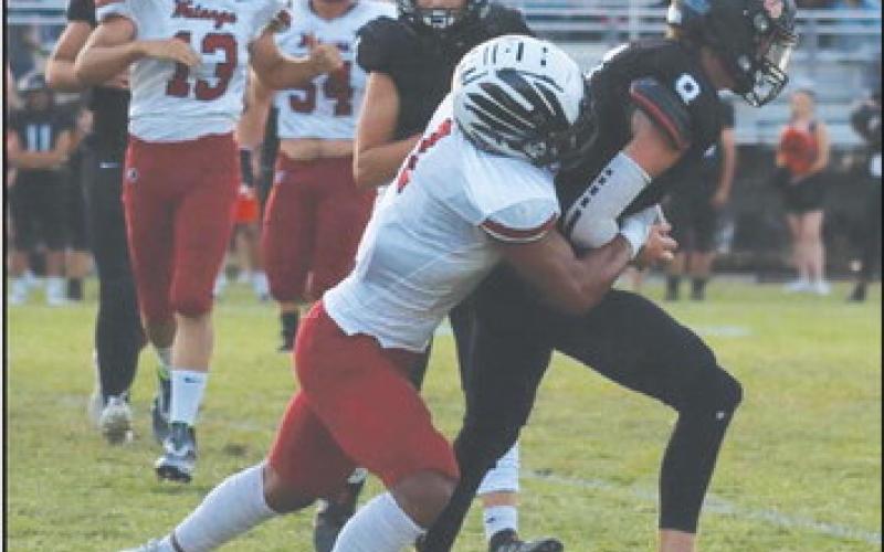 Chris Sanders tackles a Crescent player.