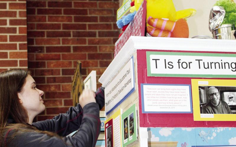 Hannah Hoffman works on her display so that photos may be sent to the sponsors of her $1,000 Prize for winning the National History Day Competition in College Park Maryland. Photo by Connie Burcham