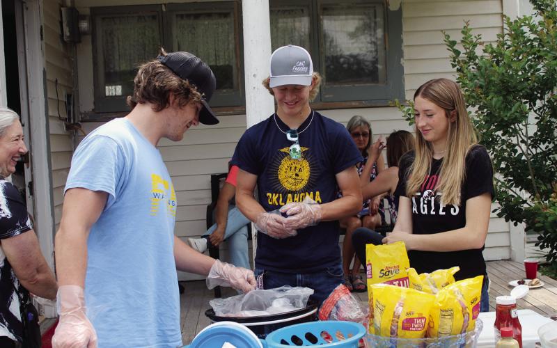Dayson Cash, Brayden Cowan and Reese Coleman volunteer Saturday at the Ferguson Home (backyard) serving hotdogs and chips. There were about 50 visitors, more than half requesting tours.