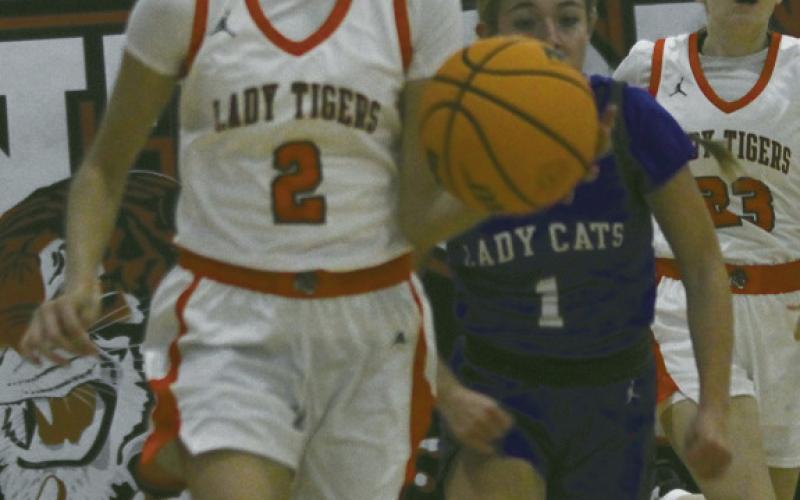 (ABOVE) Hayden Estrada puts the fake on Covington player. (ABOVE RIGHT) Head Coach Jamie Davis presents Kamdyn Hulse with a commemorative ball marking her 1,000 th career point achieved during the Canton Tournament. ATRIGHT) Kamdyn Hulse shows how she got to 1,000 while (AT LEFT) Kynzlee Hulse shows the same potential.