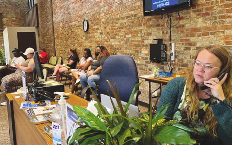 Sabria Blackwell, a Career Coordinator at the Oklahoma Works American Job Center in Oklahoma City, took a call on July 6. Oklahomans can file unemployment claims or appeals, find job postings and receive training and other guidance at the center. (Lionel Ramos/Oklahoma Watch)