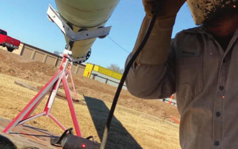 Blayne Barnes works on welding parts of a 60-foot cross together. The cross is being erected at the Watonga Church of the Nazerene. Photo Provided Watonga Republican