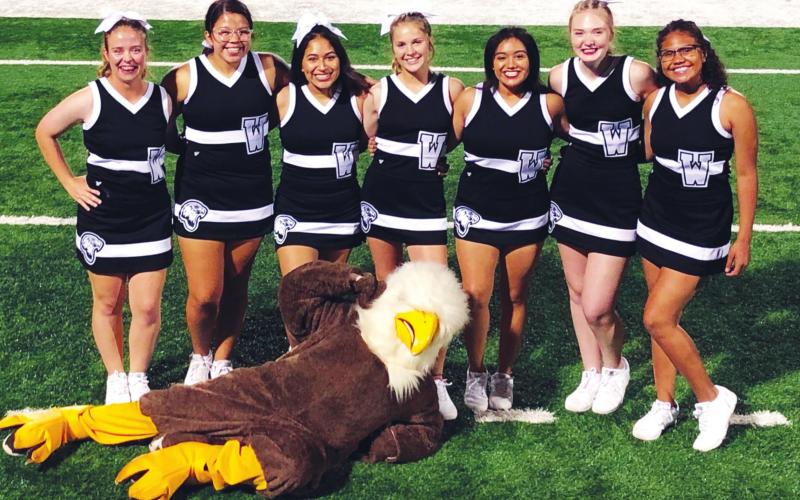 (Above) The Watonga High School varsity cheerleaders pose for a picture on the field with the Eagles’ mascot on Sept. 13, 2019, prior to Watonga’s 22-14 victory over the Alva Goldbugs in a game held at Northwestern Oklahoma State University. Photo Courtesy of Becky Cope Watonga Republican