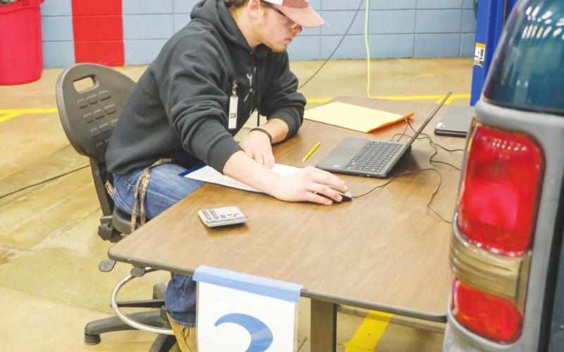 Brandon Wiggins, Watonga High School student, works at a laptop diagnosing an engine problem at the Division SkillsUSA contest at Fairview. He was one of four CTTC students who won a local contest to advance to the division competition. CTTC | Watonga Rep