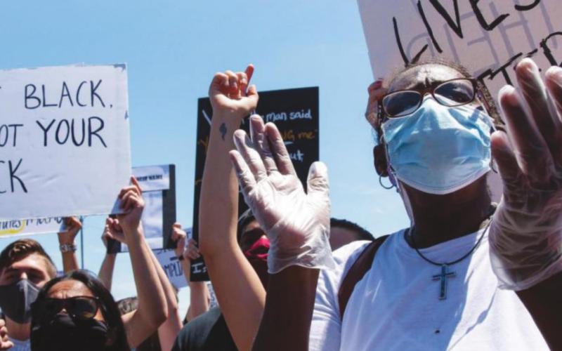 A woman cheers at a Black Lives Matter Protest in northeast Oklahoma City on May 31. The gathering was prompted by the killing of George Floyd, a black man in Minnesota. (Whitney Bryen/Oklahoma Watch)