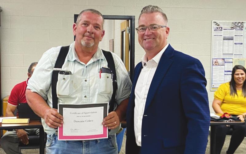 Watonga Superintendent Kyle Hilterbran (right) presents a certificate of appreciation to Duwane Crites for his efforts over the summer. Crites led extensive remodeling projects at all Watonga school campuses.
