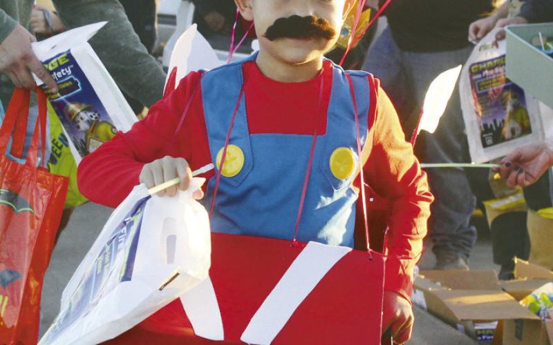 It was all fun and games, candy and make believe at Huff Lorang Park on Oct. 30 for Trunk or Treat. Shown are just a few of the cute kids who came out for the festivities. (ABOVE)Mario was a very popular costume this year. (AT RIGHT) This little