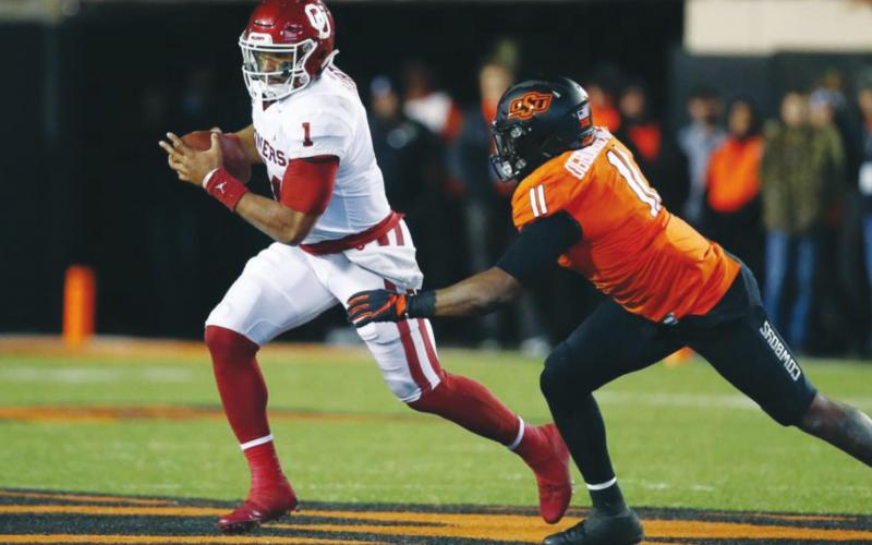 (Above) Former University of Oklahoma quarterback Jalen Hurts (1) is pursued by Oklahoma State University linebacker Amen Ogbongbemiga (11) on Nov. 30, 2019, in the second half of the 2019 Bedlam Series college football game at Boone Pickens Stadium in Stillwater. Sue Ogrocki AP Photo
