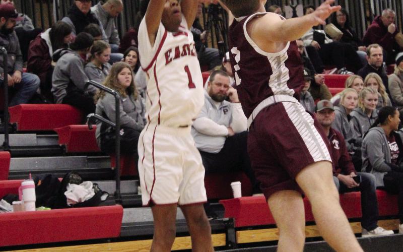 Above, left, AJ Johnson shoots for three, while at right Jonah