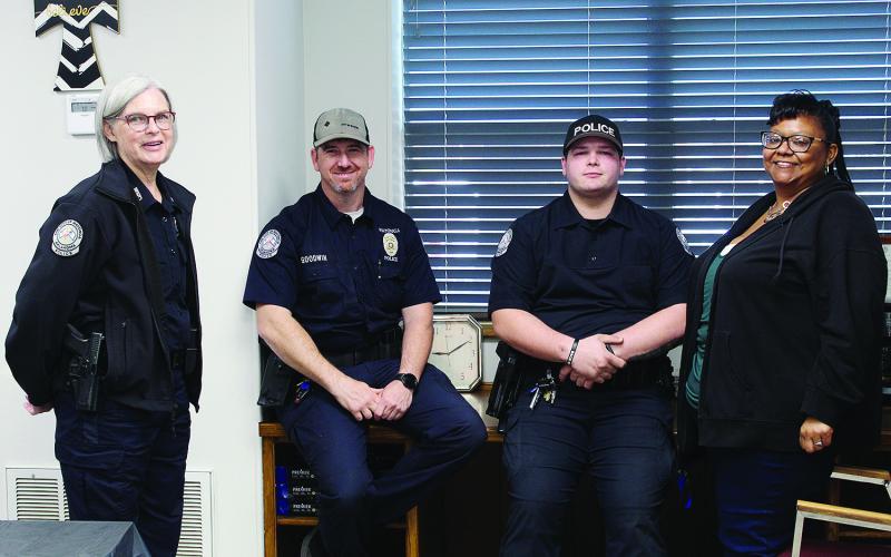 Chief of Police Beth Massey poses Friday with officers Monty Goodwin, Kagan Rinehart and dispatcher and office manager Anitra Harper. The occassion was the open house at the newly remodeled Watonga Police Department.