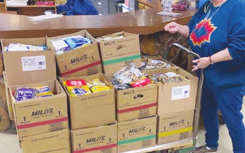 Opal Clyden wheels out food and goods boxes ready for Senior Nutrition day. (Photo provided by Carla Flynn)