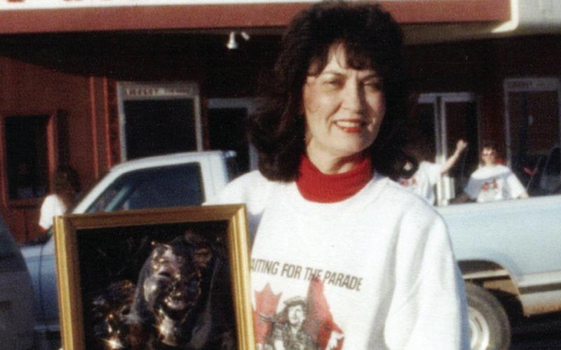 Patt Ward Curtin in front of the Liberty Theatre marquee with the state winning plaque from the play she directed, Waiting for the Parade. This show went on to place fourth at the National Competition held in Knoxville, Tenn. The crew transported their set in a stock trailer.