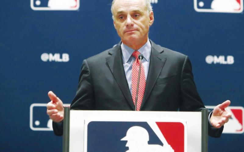 (Above) In this Nov. 21, 2019, file photo, baseball commissioner Rob Manfred speaks to the media at the owners meeting in Arlington, Texas. The chance that there will be no Major League Baseball season increased substantially Monday, June 15, 2020, when the commissioner's office told the players' association it will not proceed with a schedule amid the coronavirus pandemic unless the union waives its right to claim management violated a March agreement between the feuding sides. LM Otero AP Photo