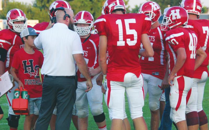 (Above) Hinton High School varsity football first-year head coach Grant Potter speaks with some of his players on Sept. 6, 2019 during a game vs. Mooreland High School. ANDREW SALMI/HINTON RECORD