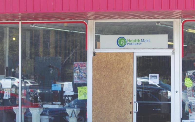 A door at Swann Pharmacy is boarded up one week after thieves broke in and stole prescription drugs on Tuesday, Aug. 24, 2021.