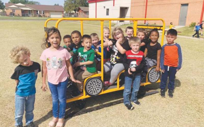 Watonga Elementary students enjoying their new school bus toy. The new toy was purchsed by the Watonga School Board for the little playground over the summer, and has just recently been delivered and installed. Watonga Public Schools Watonga Republican