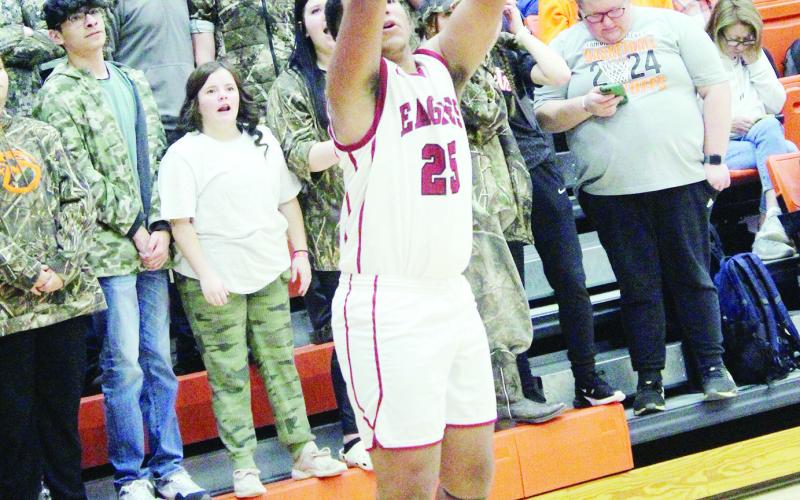 The Eagles basketball team played at Merritt Feb. 22, beating Sayre 4742, staying alive to play Fairview Feb. 23, but were unable to come home with the W ending the game 37-89 and closing the books on their season. At left, Trenton Smithson with the jumper. At right, Tyshon Wilson shoots.