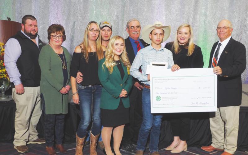 Tyler Sawyer receiving his scholarship alongside was Becky Bedwell, Blaine County OSU 4-H Educator; Karl Riffle, Okeene Vocation Agriculture Instructor; Parents of Tyler, Trisa and Brandon Sawyer; Elizabeth Chamber, State 4-H president; David Gammill, Vice-Chairman of the of the Oklahoma Wheat Commission, JanLee Rowlett, Oklahoma Department of Agriculture; Keith Kisling, Oklahoma Wheat Research Foundation.