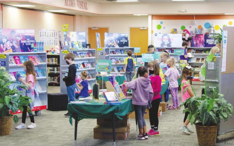 Watonga students peruse the shelves of the book fair.
