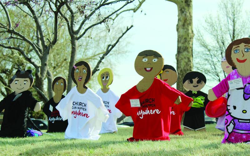 The wooden children on the Blaine County Courthouse lawn represent verified cases of child abuse in the county in the past year.