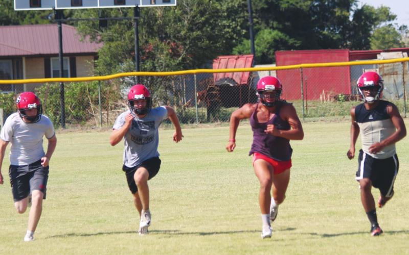 Players from the Geary High School varsity football team run sprints on Aug. 15, 2019, at the end of practice. Andrew Salmi I The Geary Star