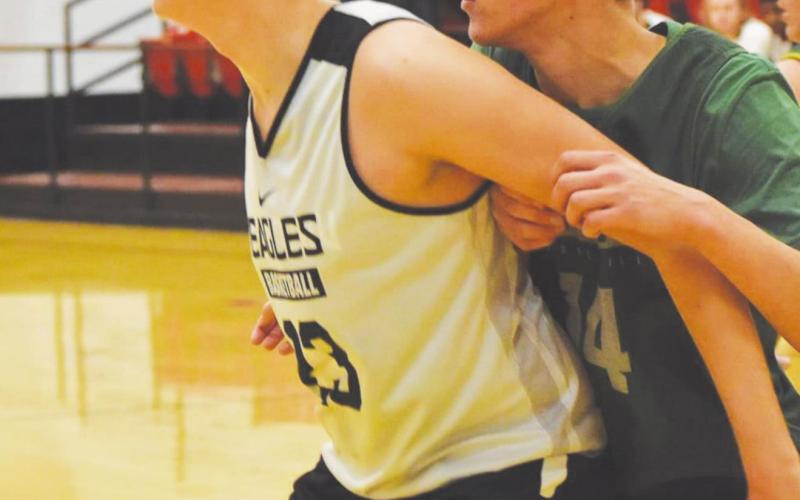 (Photo above) Tucker Estep goes for the shot during a scrimmage against Amber-Pocasset. (Photo below) Tucker Estep blocks a player during a scrimmage against Amber-Pocasset.