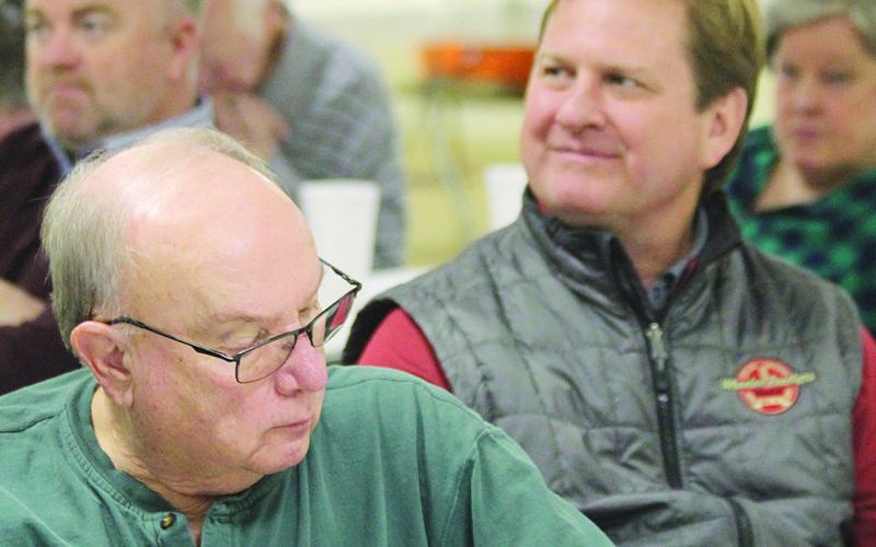 Bidders including Todd Lafferty of Wheeler Bros. and Superintendent Kyle Hilterbran keep an eye on the prices as they are called out.
