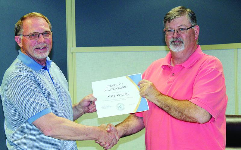 Mayor Bill Seitter presents a certificate of appreciation Tuesday evening to outgoing Watonga City Council member Allen Cowan. Cowan did not run for re-election after five years on council. He said it had been a real privilege to serve the city as it was changing and beginning to gain ground on modernization.