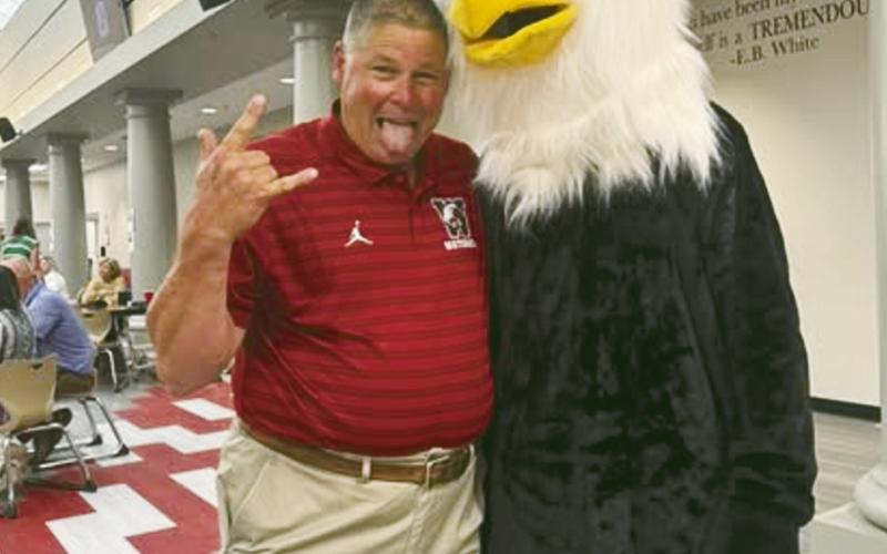 (ABOVE) Watonga Athletic Director Kirk Wilson hams it up Thursday with the Eagle mascot during teacher in-service days at the high school. Meanwhile, at Geary High School some goats showed up for the first day of school
