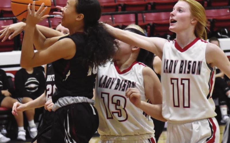 Geary’s Kandace Pitts reaches in for the ball during a game last week. The Lady Bison fell to Watonga 58- 21. (Photo provided by Brenda Geels)