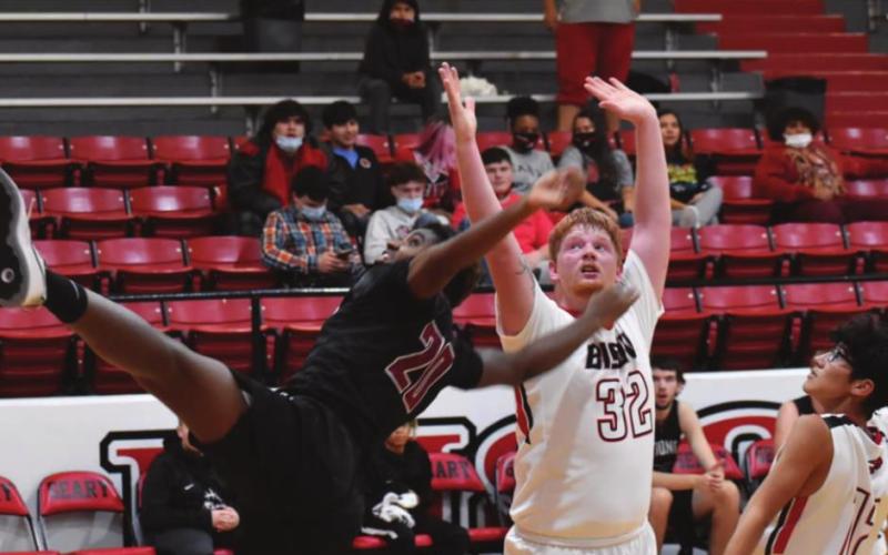Geary’s Keaton Akridge goes up for two points in front of a sprawling Watonga defender. The team lost to Watonga, 71-44. (Photo provided by Brenda Geels)