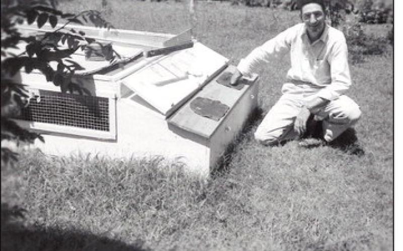 George Wint was one of the first graduates of the OSU Fish and Wildlife Research Unit. Here, he sits alongside a quail coop that he used for his research on the release of pen-raised quail for increasing wild populations. Wint later became director of the Oklahoma Department of Wildlife Conservation in the 1970s.