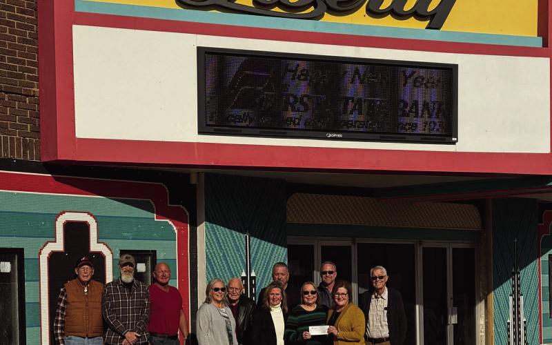 L-R, Dr. Larry Major, Josh Cox, Lane Edsall, Lisa Major-Seitter, Chub Edsall, Mark Taylor, Loren Parham, Basil Taylor, Melanie Taylor-McCrary, Denise Green and Lori Osmus. When WTC started its campaign to pay for the renovation of the front of the Liberty, First State Bank of Watonga was one of the first to support them with a donation, presenting the group with a $2500 check. Loren Parham explained that when the campaign was over, First State would give WTC another $2500 check.
