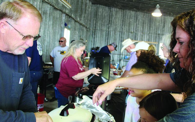 Mayor Bill Seitter and WEDA director Kim Jenkins prepare breakfast for the fly-in held at the Watonga Regional Airport.