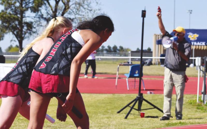 Top: Deondre Dunn competes at a track meet in Watonga on Saturday, April 24. Dunn won the 110m hurdles and the 300m hurdles, but the Watonga boys finished in fifth place overall. Below: Athletes wait for the starting gun during a track meet in Watonga on Saturday.
